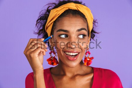Closeup image of happy mulatto woman with colorful makeup laughi Stock photo © deandrobot