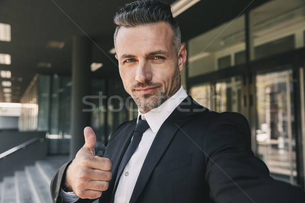 Portrait of a confident young businessman Stock photo © deandrobot