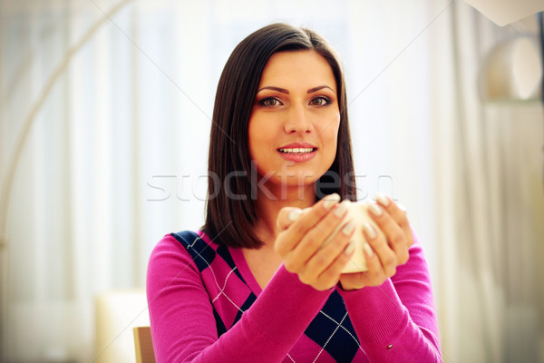 Stock photo: Middle-aged happy woman holding cup of coffee