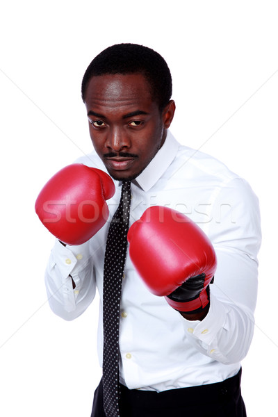 Stock photo: Business man ready to fight with boxing gloves isolated over white background