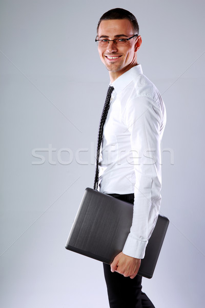 [[stock_photo]]: Heureux · affaires · permanent · portable · gris · main