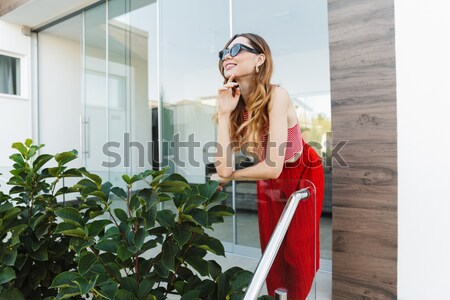 Playful woman reading book and sending kiss in the city Stock photo © deandrobot