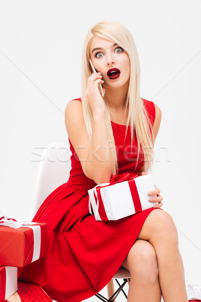 женщину красное платье представляет говорить мобильного телефона возбужденный Сток-фото © deandrobot