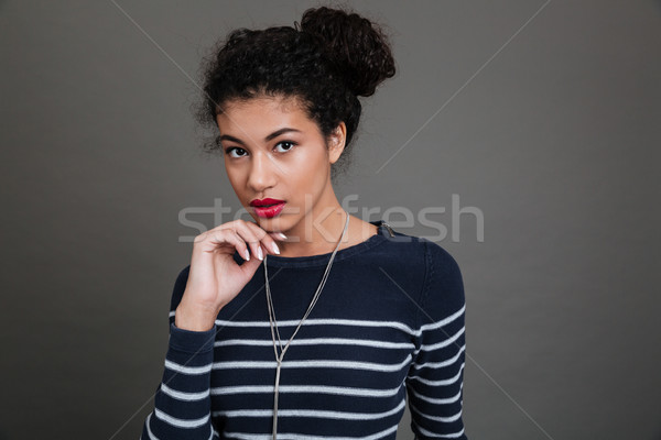 Portrait of an attractive african woman looking at camera Stock photo © deandrobot