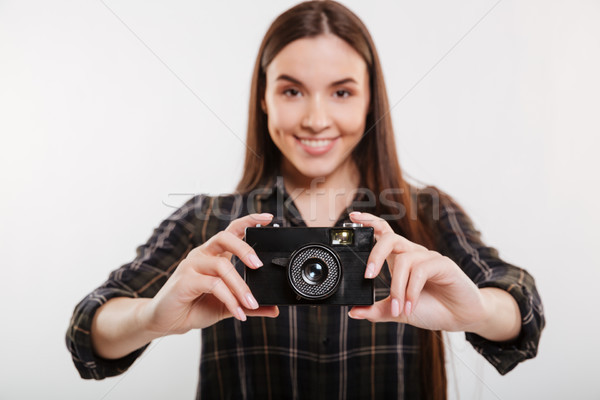 Smiling Woman in shirt holding retro camera Stock photo © deandrobot