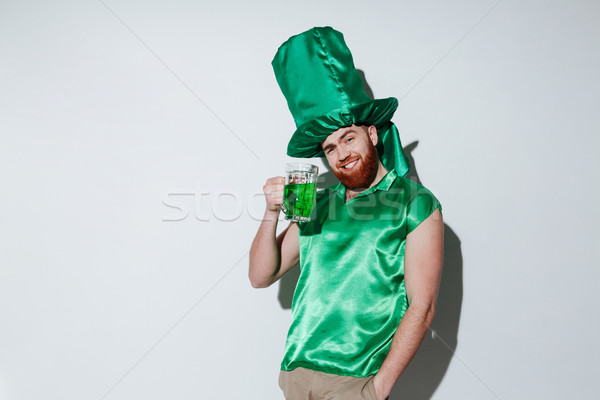 Smiling bearded man in green costume Stock photo © deandrobot