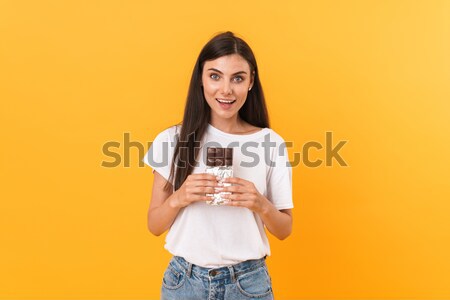 Smiling lovely young woman standing and using cell phone Stock photo © deandrobot