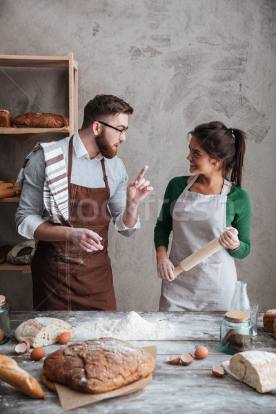 Stock photo: A woman listening the instructions of a man about baking bread