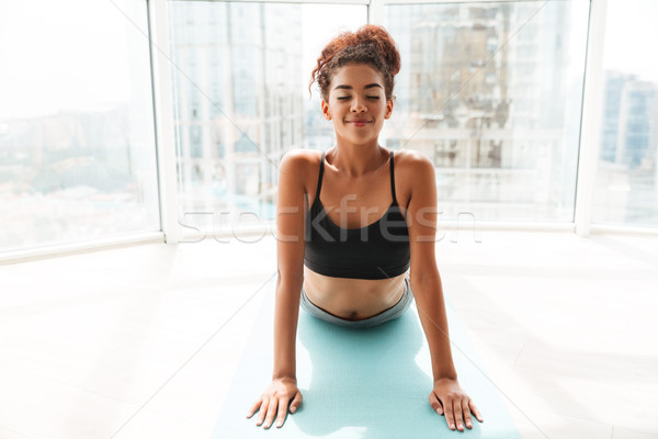 Stock photo: Young african woman making exercises at home