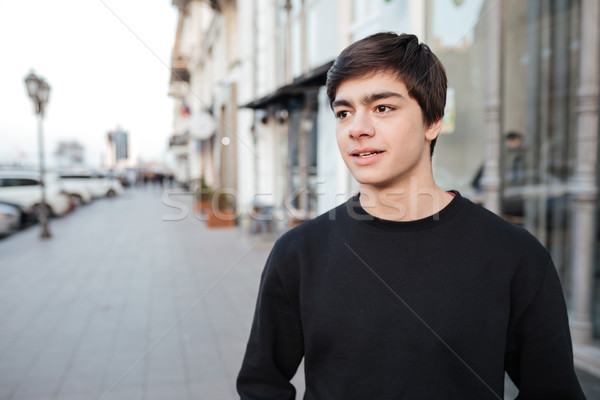 Portrait of serious young man in the street Stock photo © deandrobot