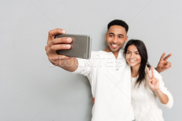 Young man and woman making photo Stock photo © deandrobot