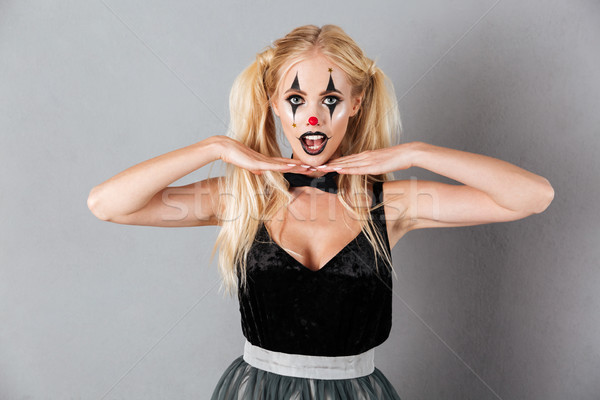 Young blonde woman in halloween make up holding her hands Stock photo © deandrobot