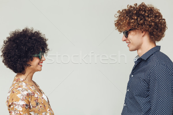 Young retro loving couple posing isolated. Looking at each other. Stock photo © deandrobot