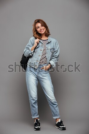 Portrait of a disappointed asian woman standing with arms folded Stock photo © deandrobot