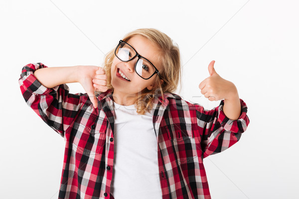 Portrait of a little girl in eyeglasses showing thumbs up Stock photo © deandrobot