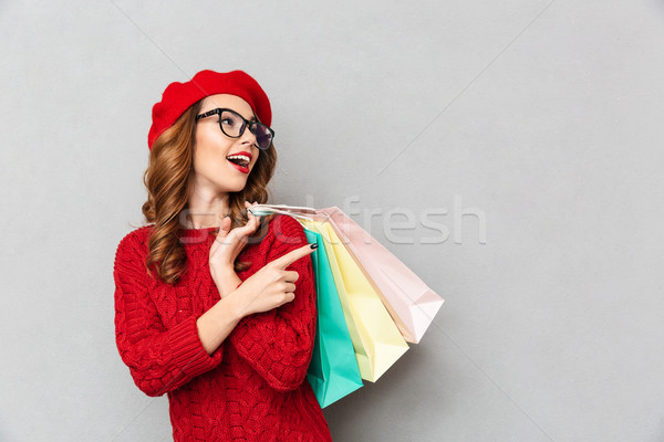 Portrait of a cheery woman dressed in red sweater Stock photo © deandrobot