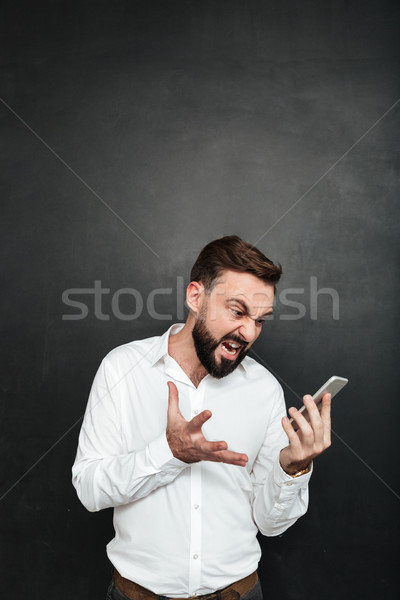 Studio photo of angry man yelling being irritated while looking  Stock photo © deandrobot