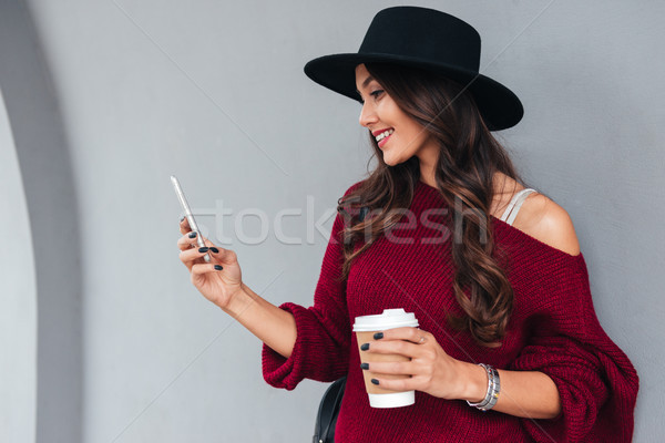 Stock photo: Portrait of a smiling young asian girl dressed in hat