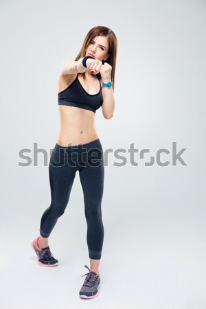 Fit young woman punching towards camera  Stock photo © deandrobot