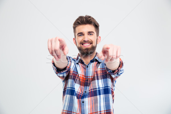 Handsome man pointing fingers at camera Stock photo © deandrobot