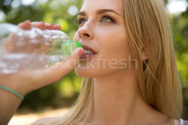 Woman dirnking water outdoors Stock photo © deandrobot