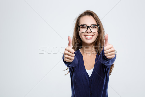 Smiling woman showing thumbs up Stock photo © deandrobot