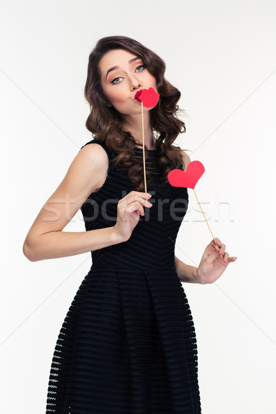 Amusing charming woman posing with paper heart and lips booth  Stock photo © deandrobot