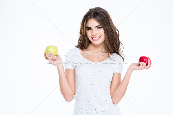 Smiling lovely woman holding two apples Stock photo © deandrobot