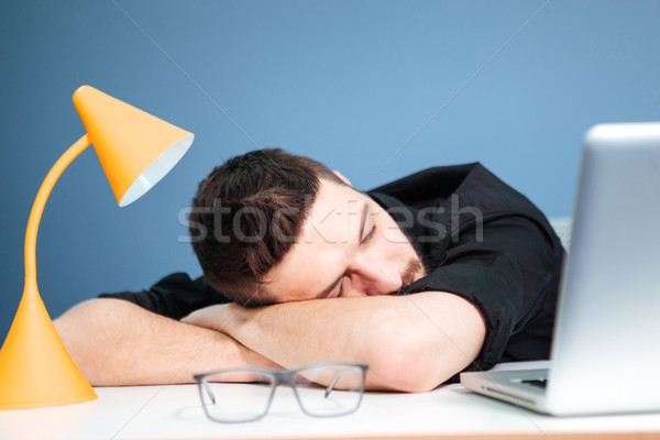 Casual businessman sleeping on the table  Stock photo © deandrobot
