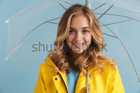 Cheerful pretty young woman standing and laughing  Stock photo © deandrobot