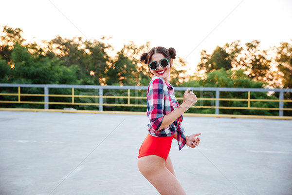 Dziewczyna okulary czerwony strój kąpielowy stwarzające odkryty Zdjęcia stock © deandrobot