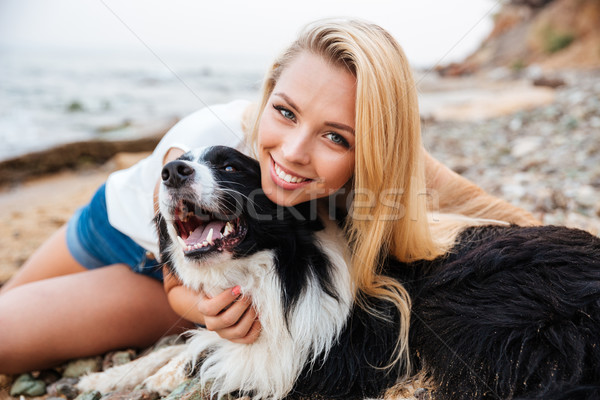 Alegre mulher sessão cão praia Foto stock © deandrobot