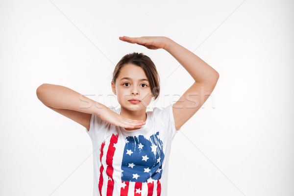 Happy young girl posing isolated over white background. Stock photo © deandrobot