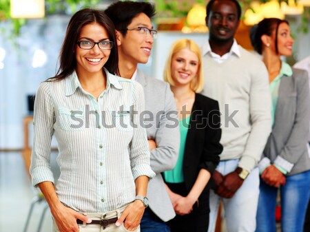 Happy businessman holding flag of Germany in front of colleagues Stock photo © deandrobot