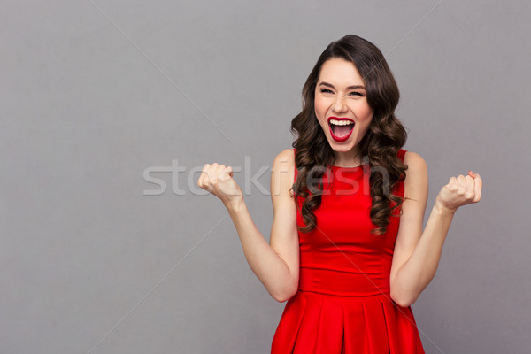 [[stock_photo]]: Femme · célébrer · succès · portrait · robe · rouge