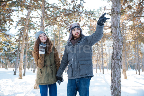 Handsome man walking with his girlfriend in winter park Stock photo © deandrobot