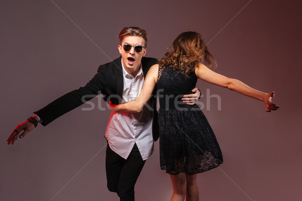 Happy young couple dancing and whirling  Stock photo © deandrobot