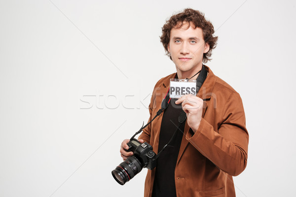 Male reporter holding card with the word press Stock photo © deandrobot