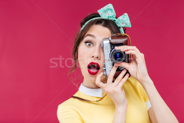 Surprised pretty pinup girl with mouth opened using vintage came Stock photo © deandrobot