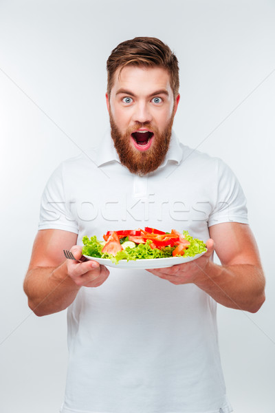 Jonge man vork eten salade Stockfoto © deandrobot
