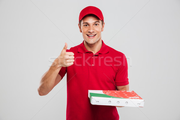 Smiling pizza delivery man Stock photo © deandrobot