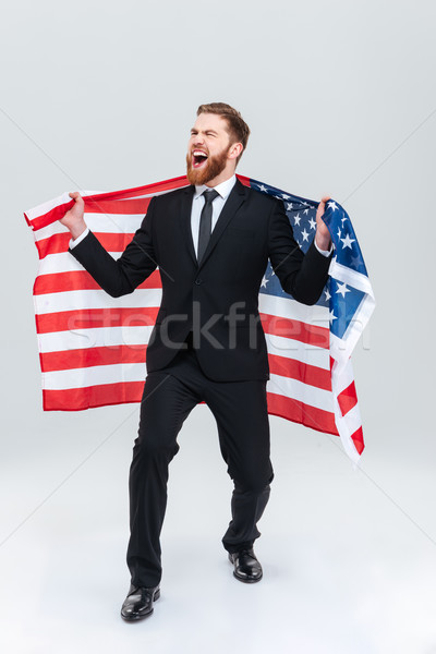 Full length business man with USA flag Stock photo © deandrobot