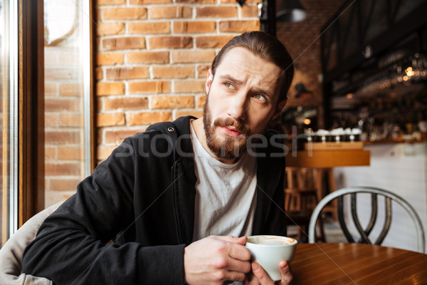 Сток-фото: серьезный · бородатый · человека · кафе · сидят · Кубок