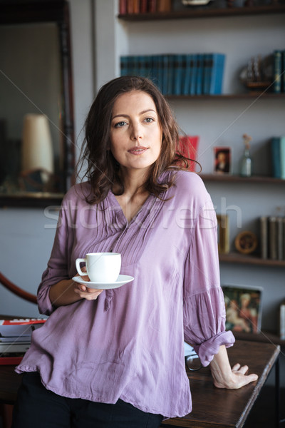 Portrait of a relaxed mature woman holding cup of coffee Stock photo © deandrobot
