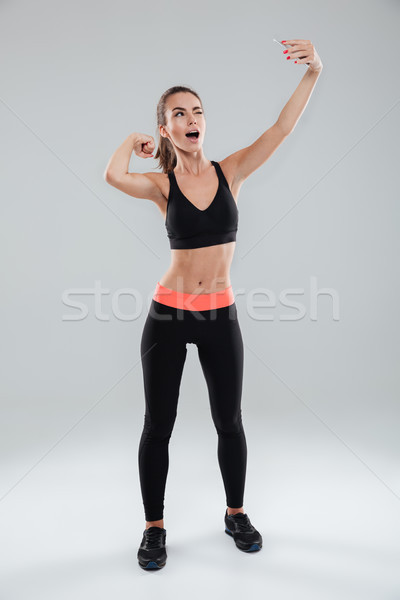 Obraz funny kobieta fitness smartphone Zdjęcia stock © deandrobot