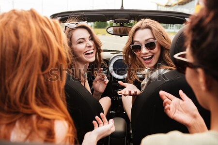 Happy emotional two young women friends sitting in car Stock photo © deandrobot