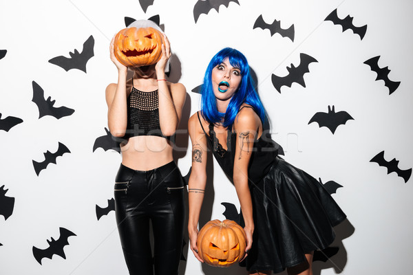 Emotional young women in halloween costumes Stock photo © deandrobot