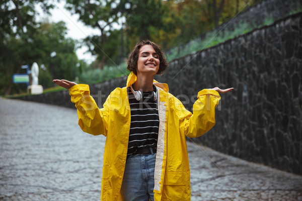 Portrait of a happy teenage girl wearing raincoat stock photo