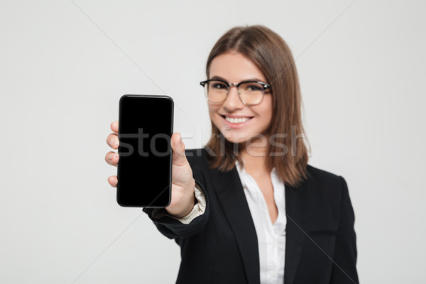 Amused happy businesswoman in eyeglasses Stock photo © deandrobot