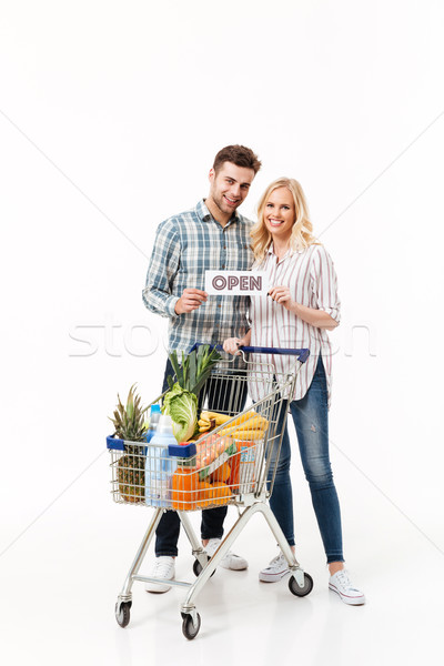 Full length portrait of a smiling couple Stock photo © deandrobot